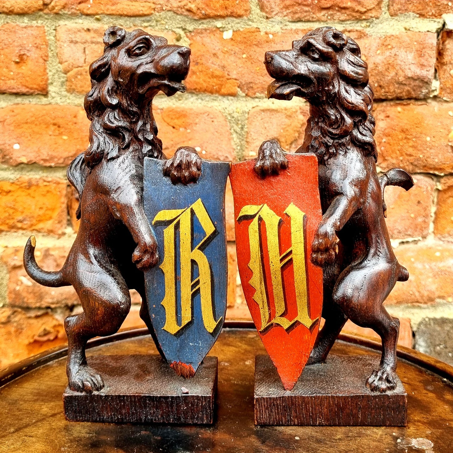 Pair of 19th Century Gothic Revival Antique Carved Oak Rampant Lions Bearing Polychromed Shields with the Initials "R" & "H"