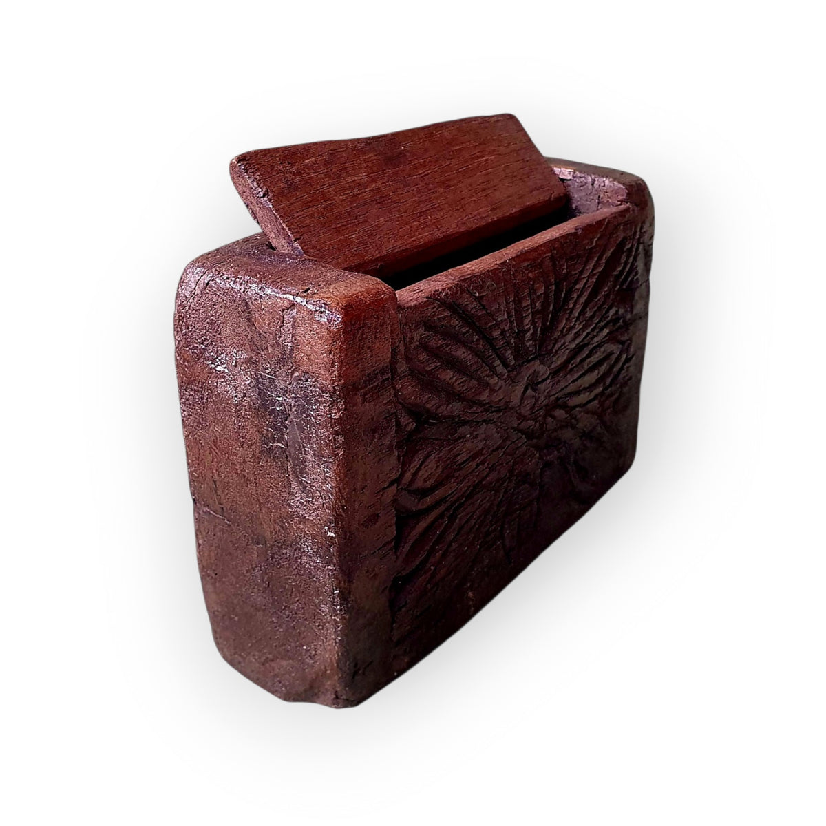 Three-quarter view of the Continental treen box showing the lid and carved front face