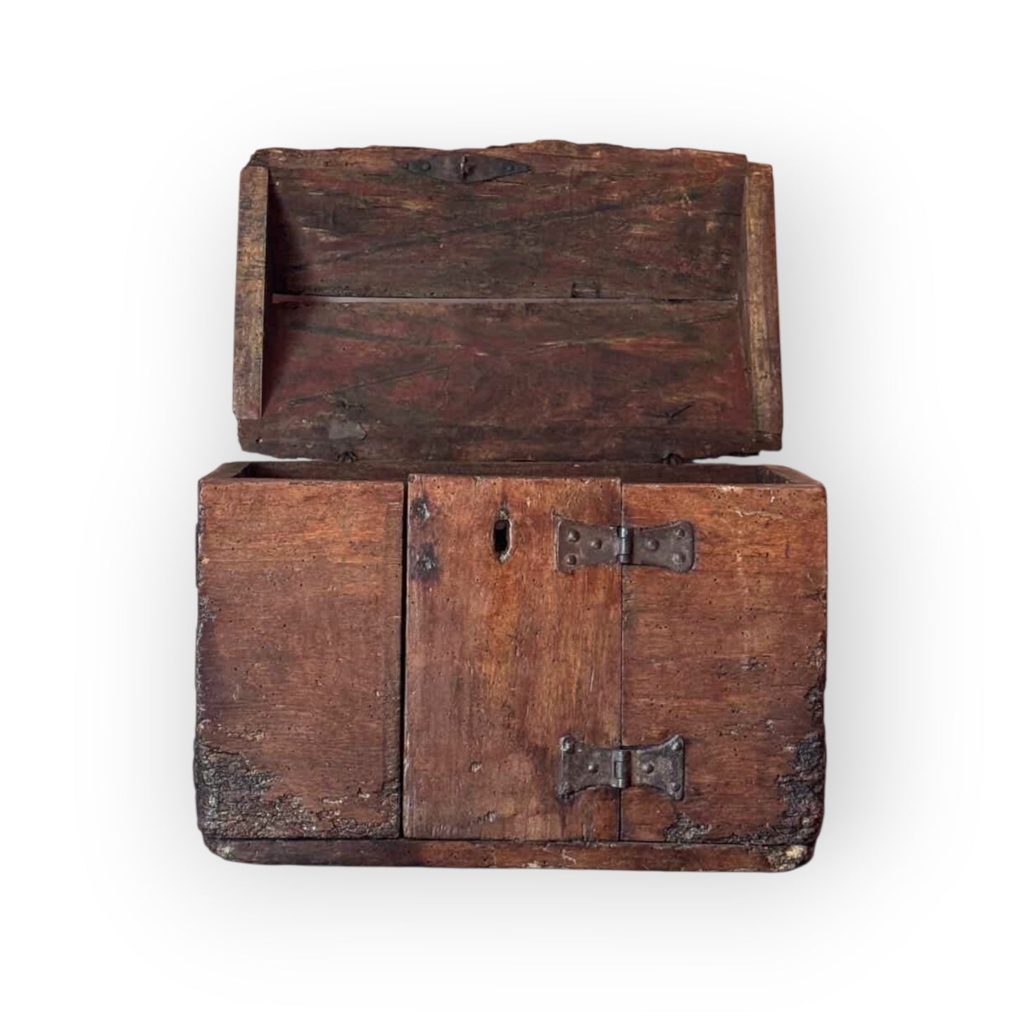 An antique wooden chest with a hinged lid, featuring dark brown wood grain and weathered metal hinges, isolated on a white background.