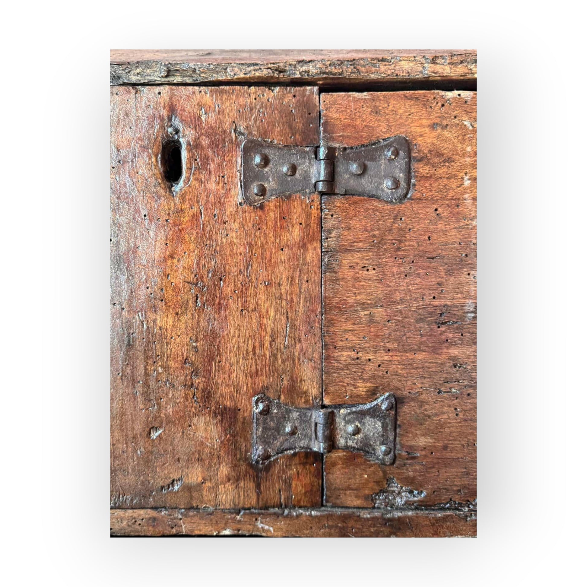 Detail of original wrought iron butterfly hinges and nailed board construction on 17th century oak alms box