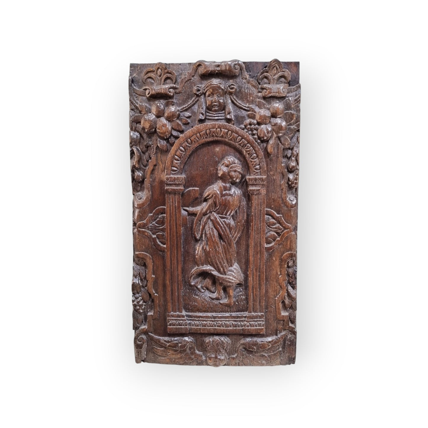 A late 16th-Century Antique Carved Oak Panel Depicting A Maiden Set Within An Arcaded Frieze