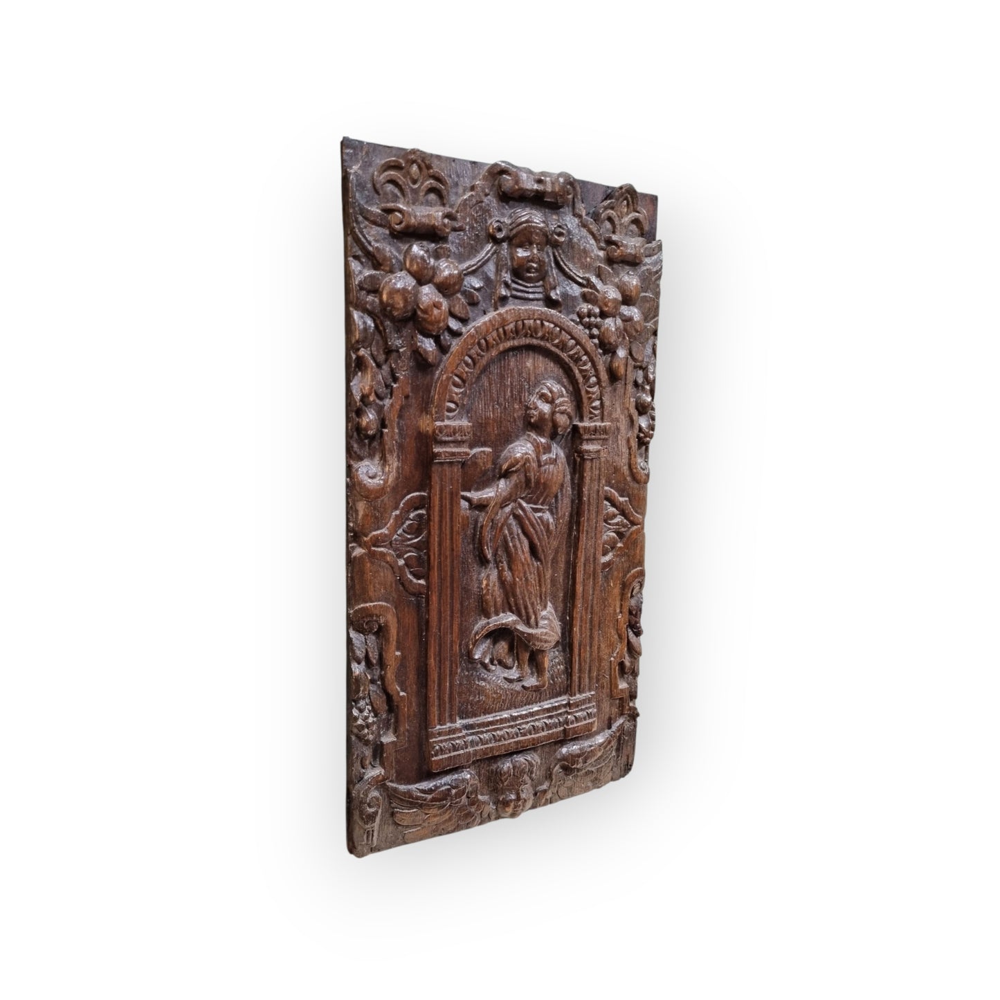 A late 16th-Century Antique Carved Oak Panel Depicting A Maiden Set Within An Arcaded Frieze