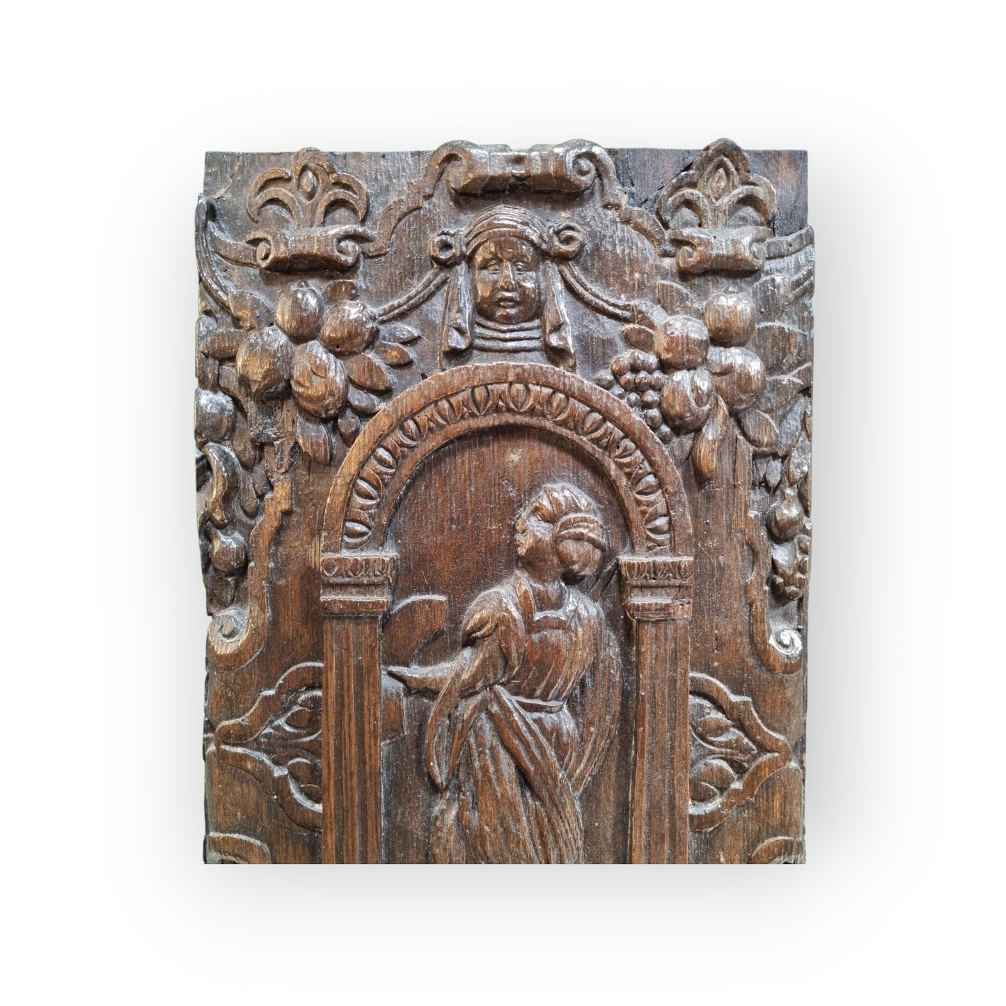 A late 16th-Century Antique Carved Oak Panel Depicting A Maiden Set Within An Arcaded Frieze
