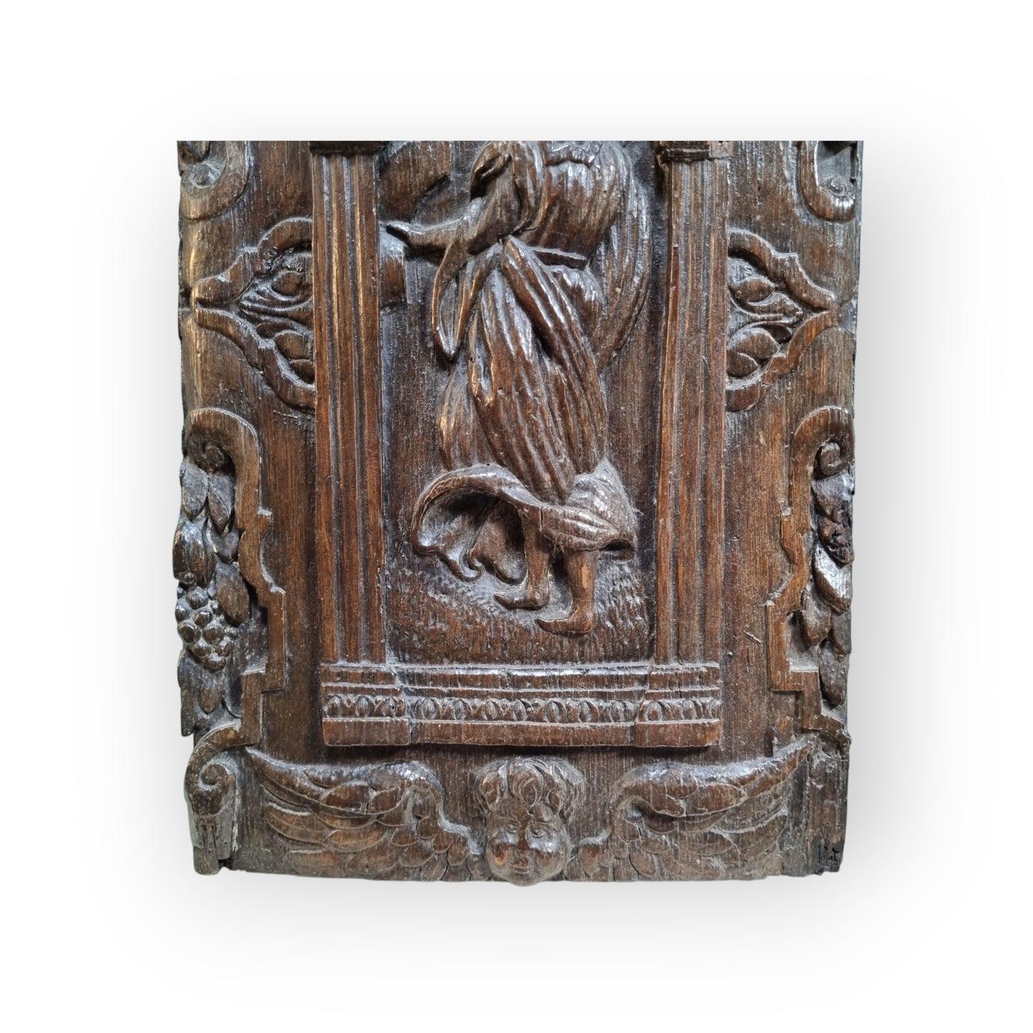 A late 16th-Century Antique Carved Oak Panel Depicting A Maiden Set Within An Arcaded Frieze