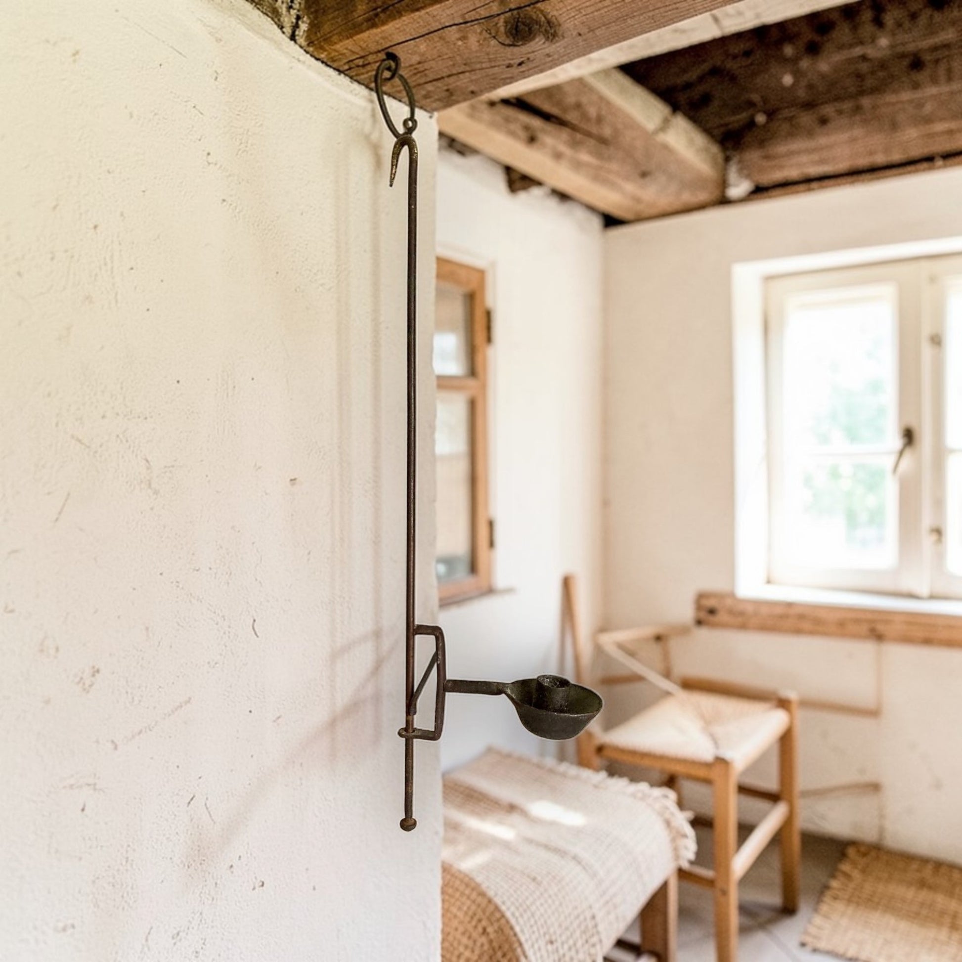 Late 18th‑century English wrought‑iron adjustable hanging candleholder with vertical stem and circular candle pan.