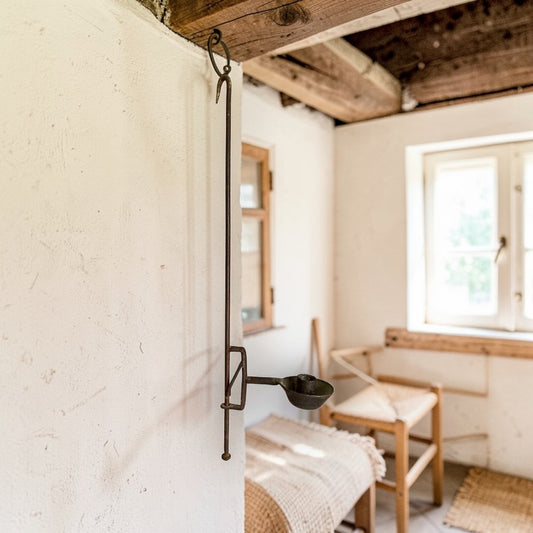 Late 18th‑century English wrought‑iron adjustable hanging candleholder with vertical stem and circular candle pan.