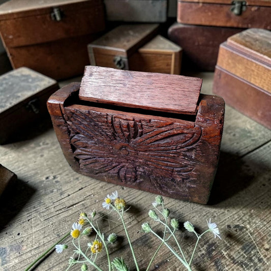 Antique Continental carved treen box with sliding lid and chip-carved rosette decoration, among other small boxes