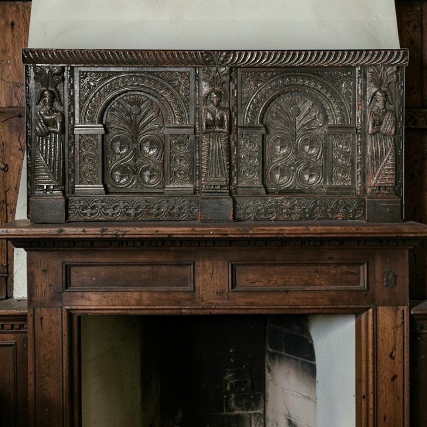 Holt Antiques at Walsingham Mill 17th-century dark oak wall panel with intricate carved caryatids and floral motifs.
