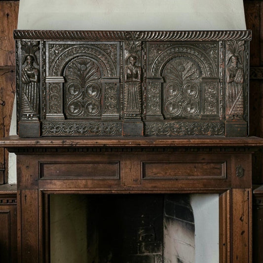 Holt Antiques at Walsingham Mill 17th-century dark oak wall panel with intricate carved caryatids and floral motifs.
