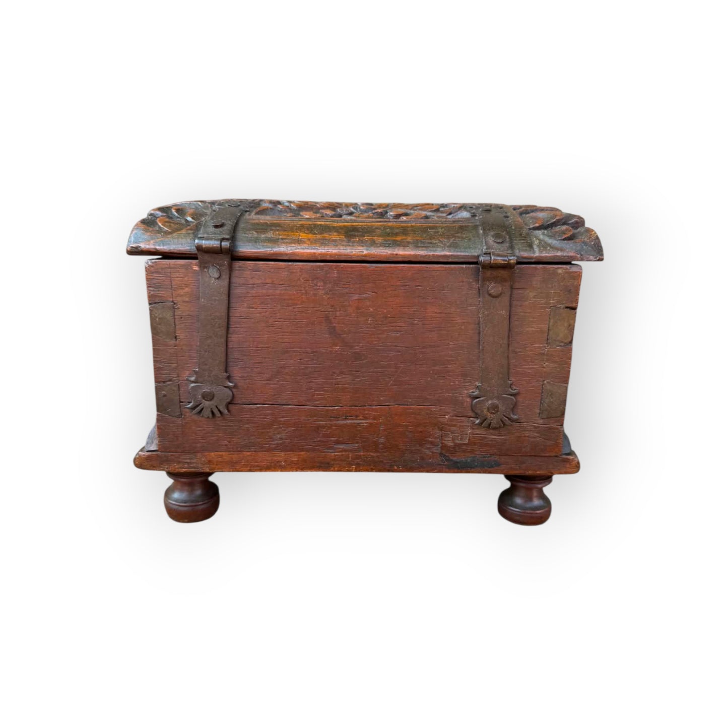 Long iron strap hinges with pierced decorative terminals riveted over lid of 17th century carved oak table casket