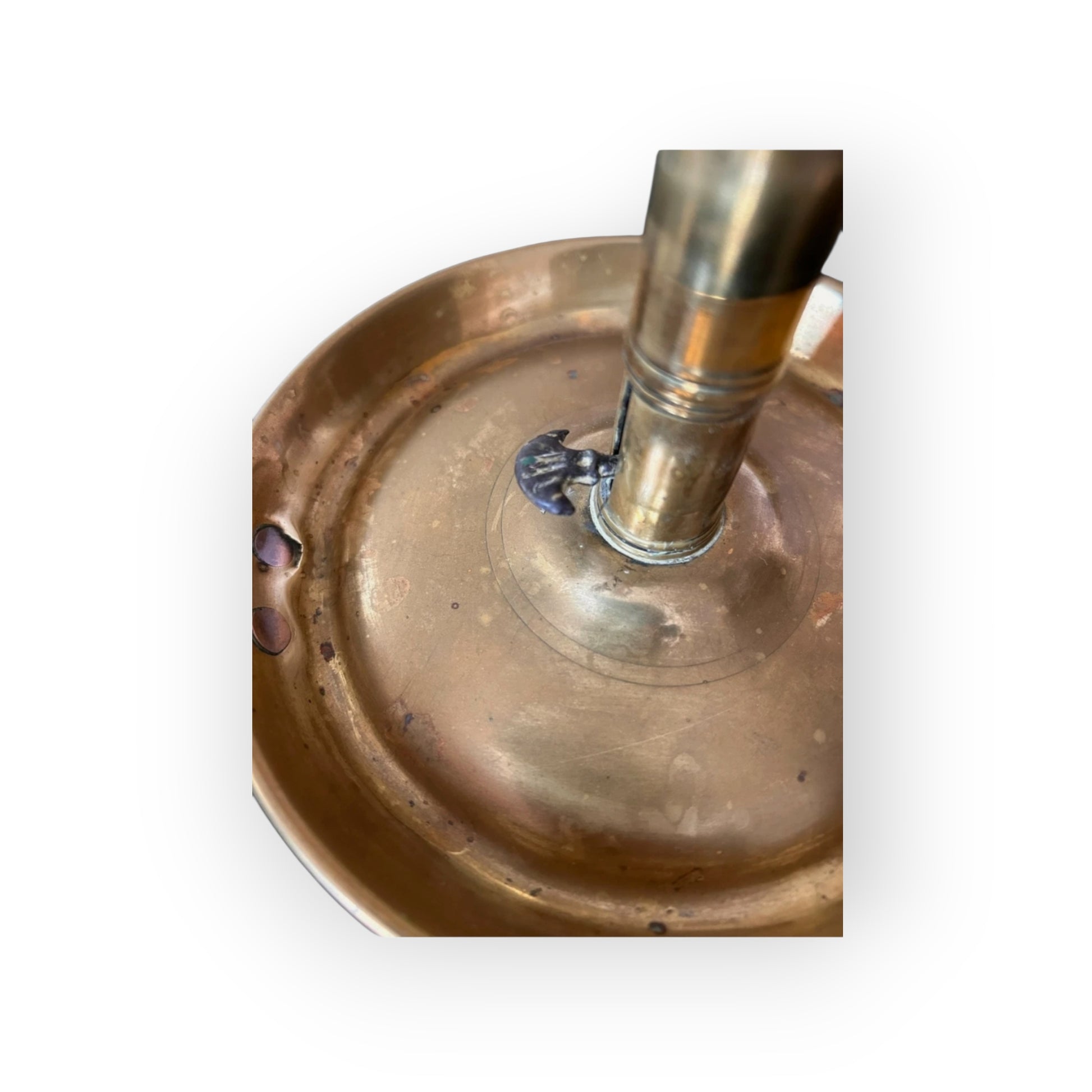 Top view of Georgian brass chamberstick drip pan showing ejector tab and rolled rim