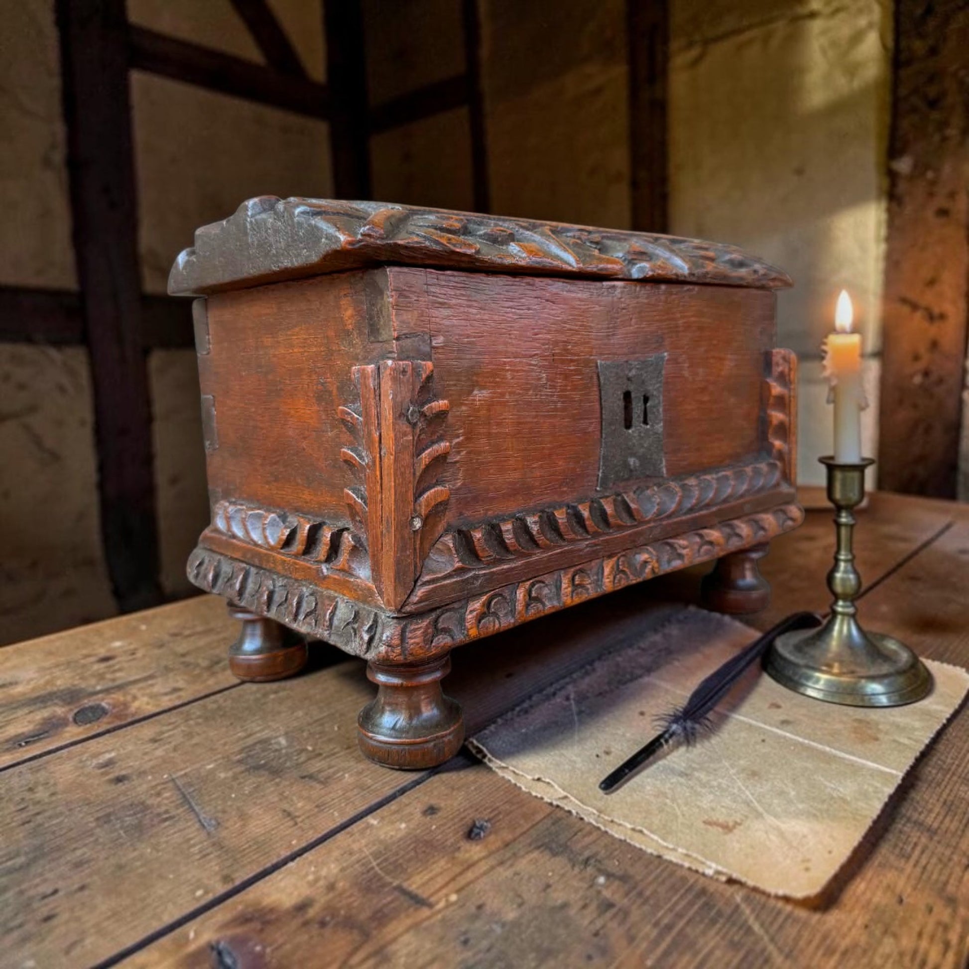 Probably Iberian 17th century carved oak casket showing foliate corner brackets and lunette carved lid edges