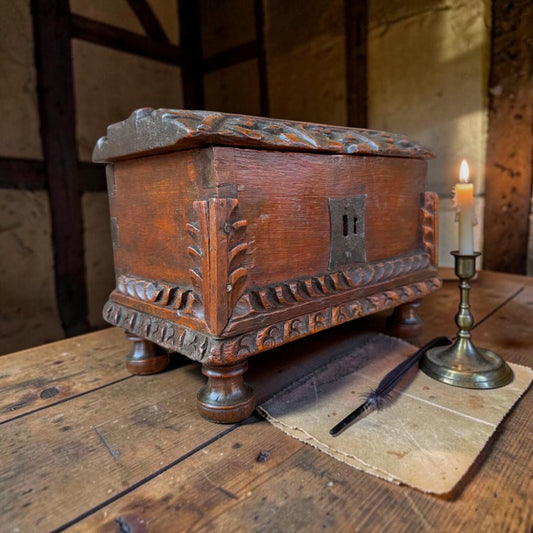 Probably Iberian 17th century carved oak casket showing foliate corner brackets and lunette carved lid edges