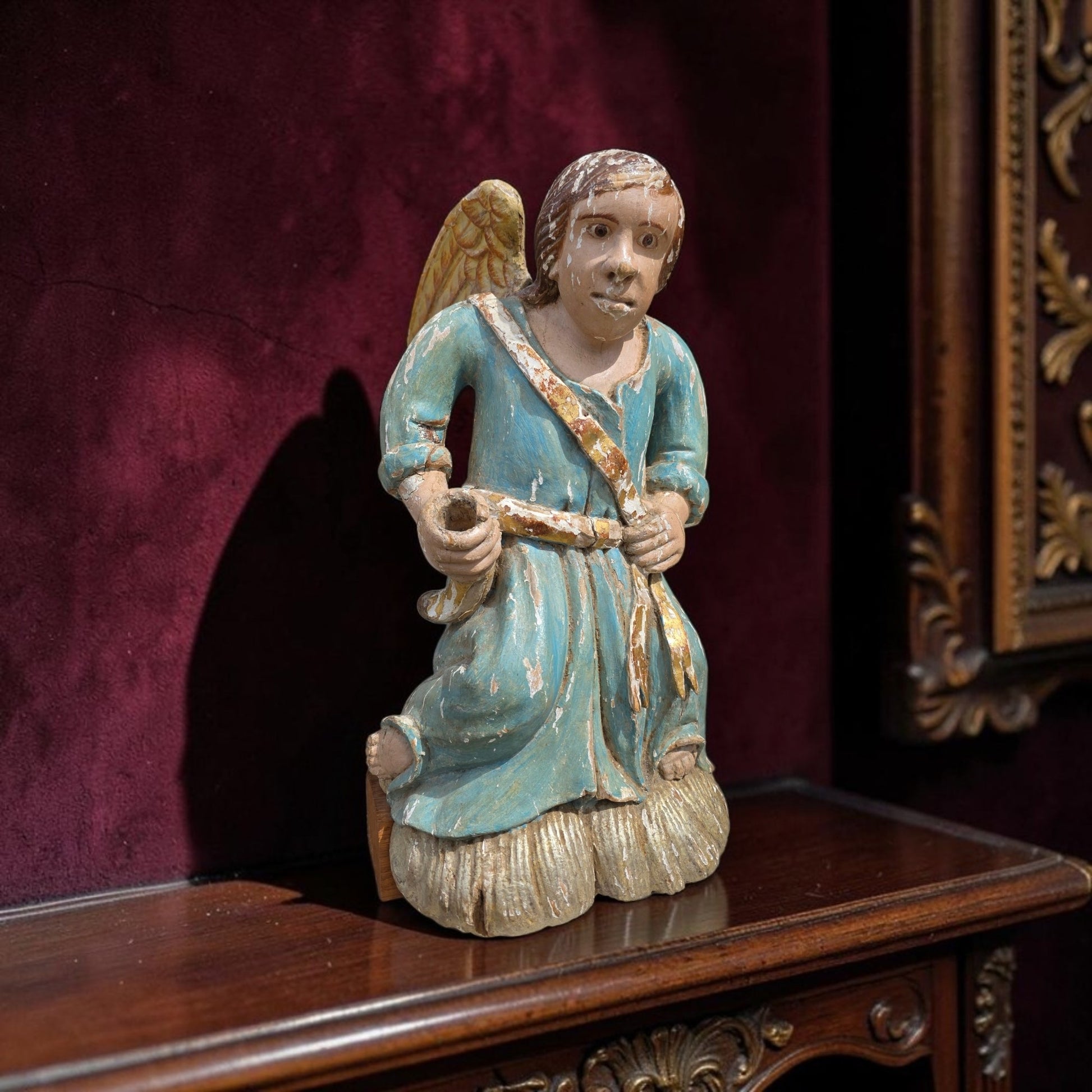 Early 18th‑century carved wooden angel in original polychrome with blue robe and gold sash