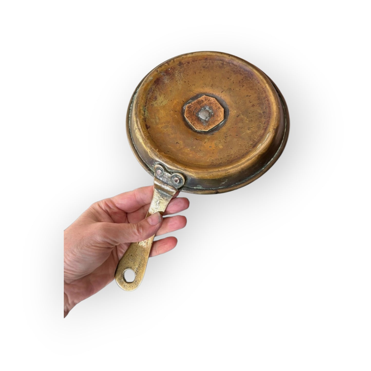 Underside of Georgian brass chamberstick showing octagonal peened nut and riveted handle attachment