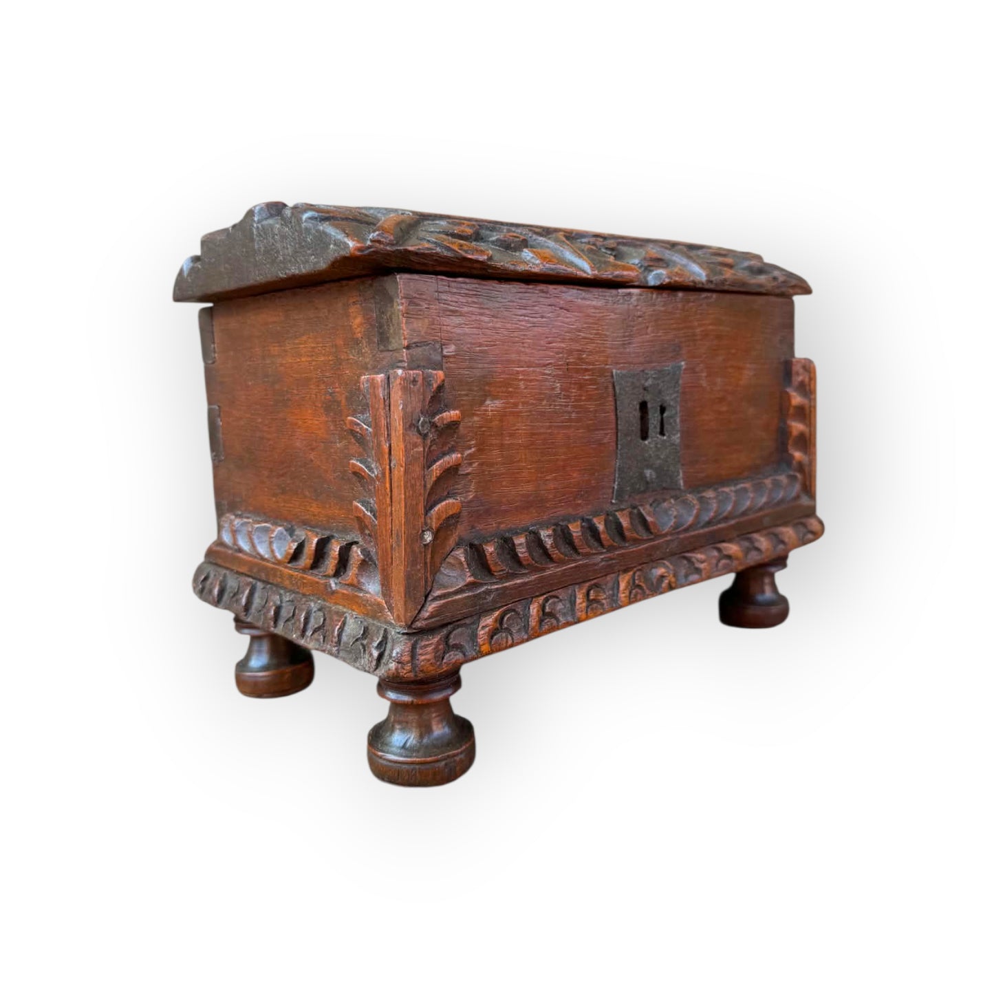 Probably Iberian 17th century carved oak casket showing foliate corner brackets and lunette carved lid edges