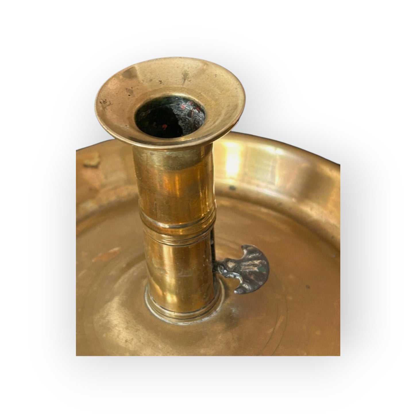 Close-up of candle socket and crescent-shaped ejector thumb-piece on the Georgian chamberstick